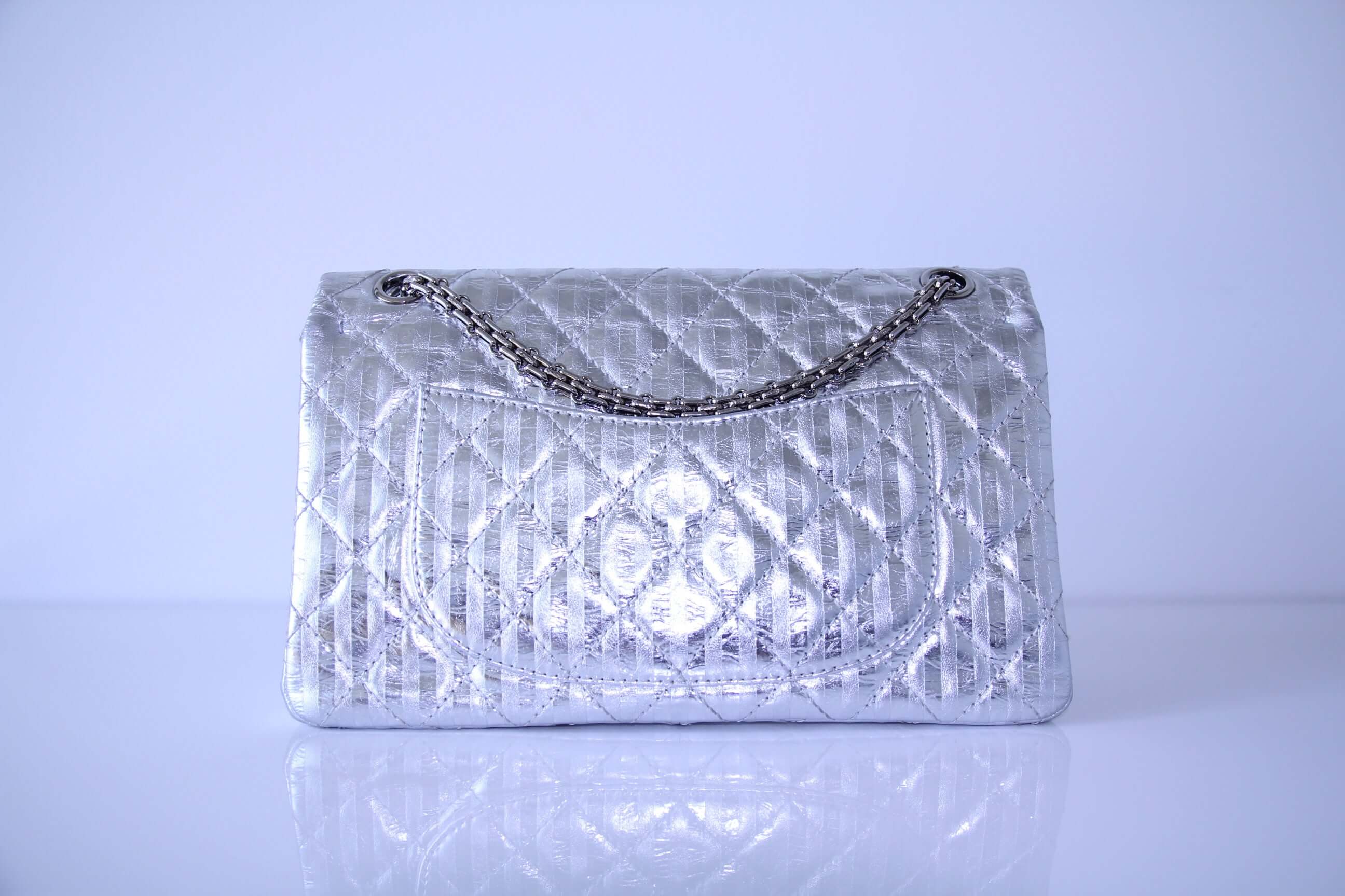 Back of Medium Chanel handbag in finished in stripped silver calfskin