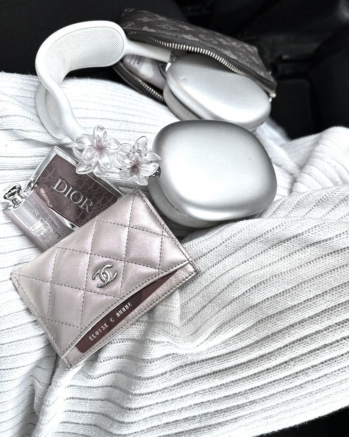 Iridescent silver Chanel Cardholder with Dior makeup and Silver Apple Air Max Headphones
