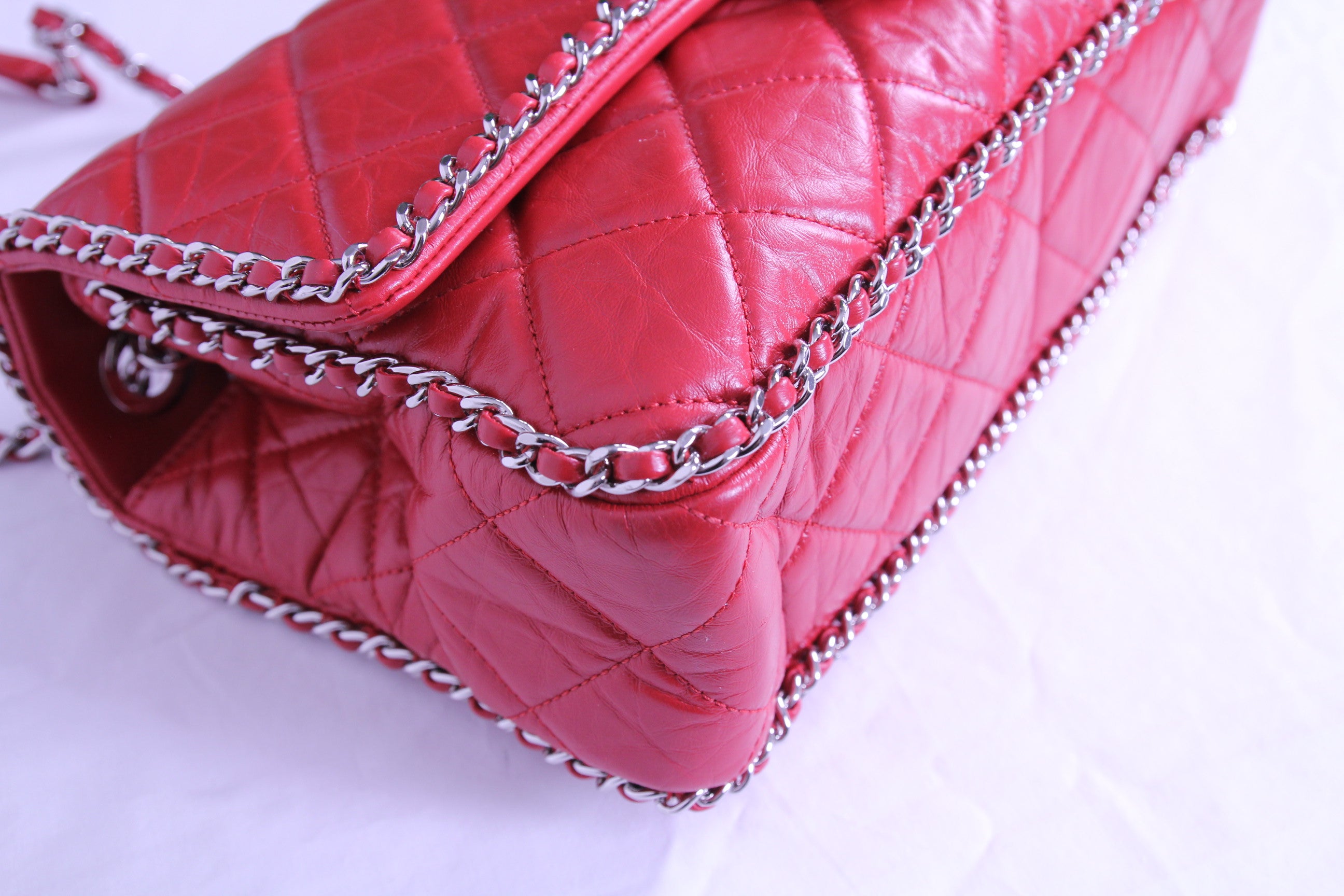 Corner of large Chanel flap finished in aged red calfskin
