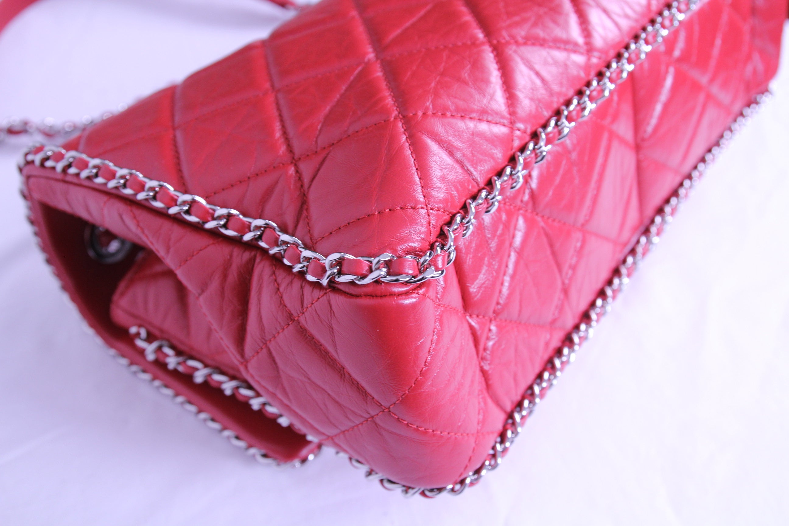 Corner of large Chanel flap finished in aged red calfskin
