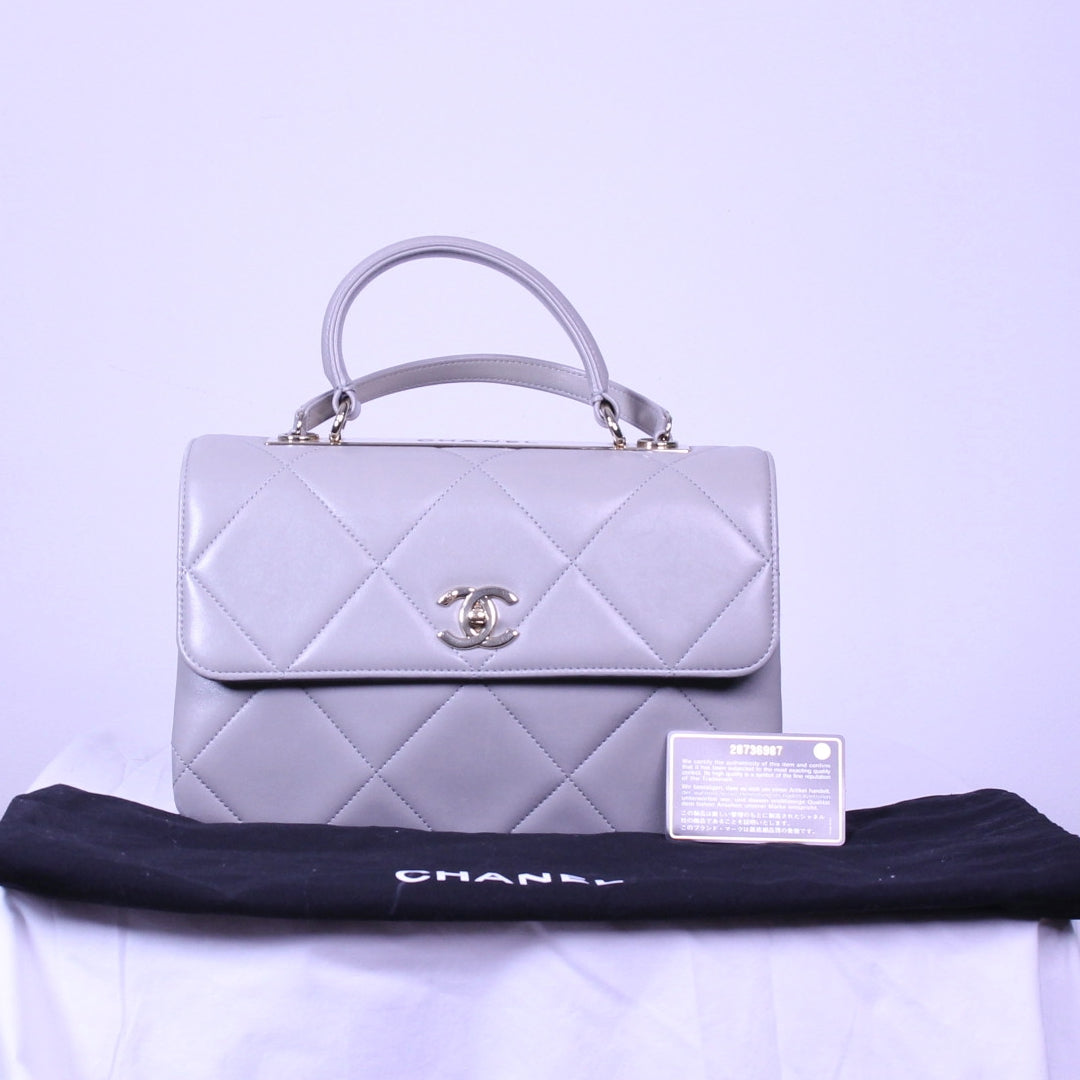 Front of Chanel trendy cc finished in grey lambskin with its authenticity card and dustbag