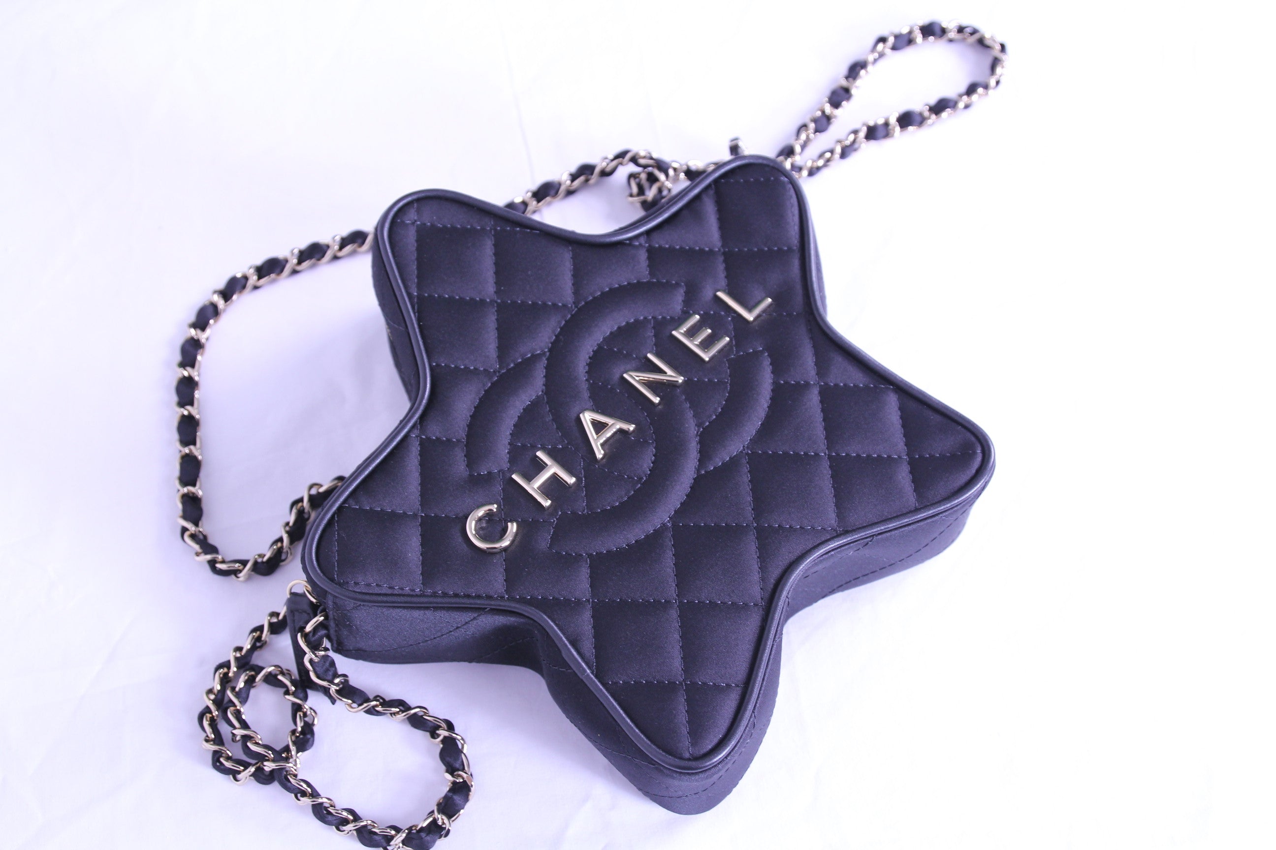 Front of Chanel star handbag in finished in black satin with chain