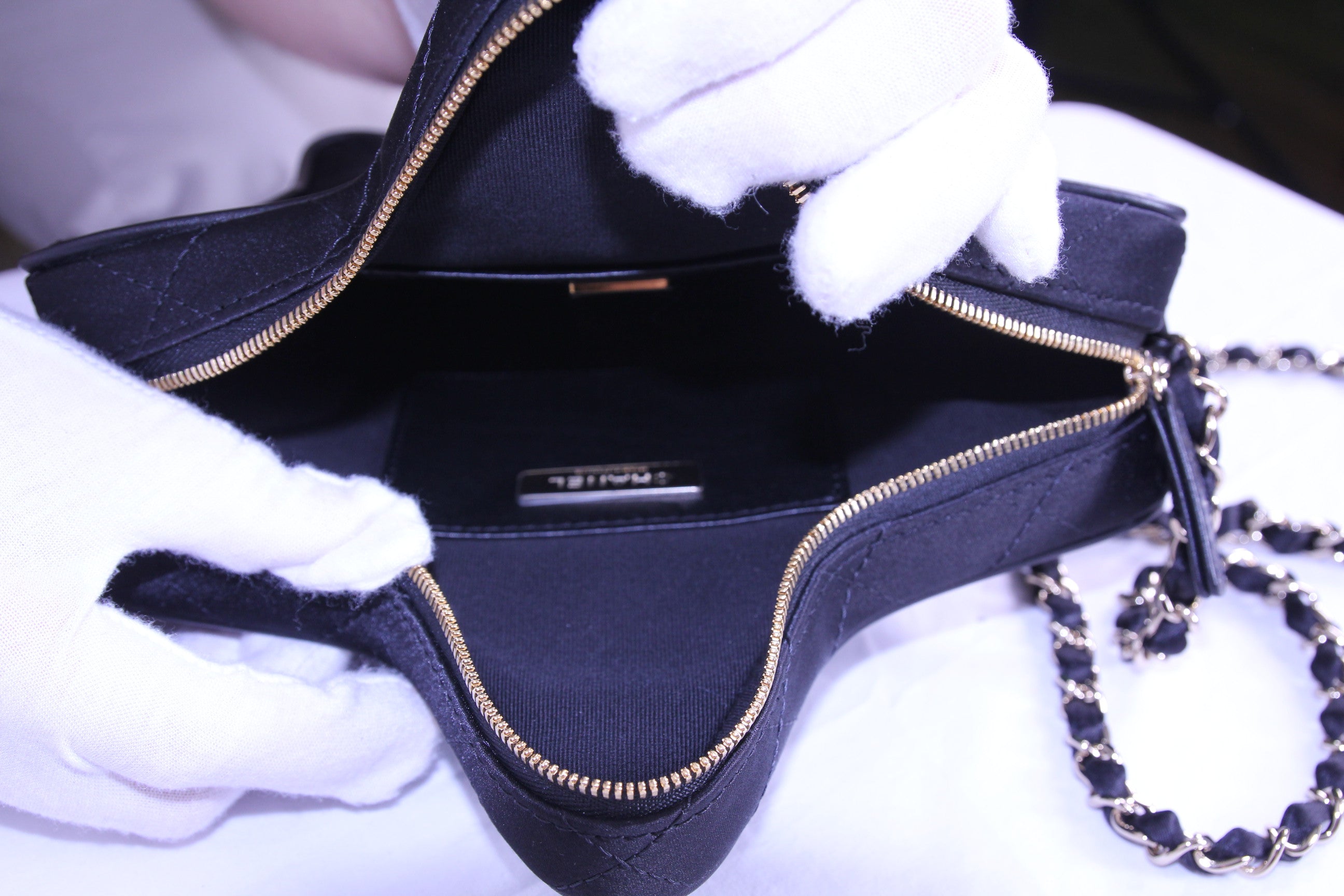 Inside of Chanel star handbag in finished in black satin