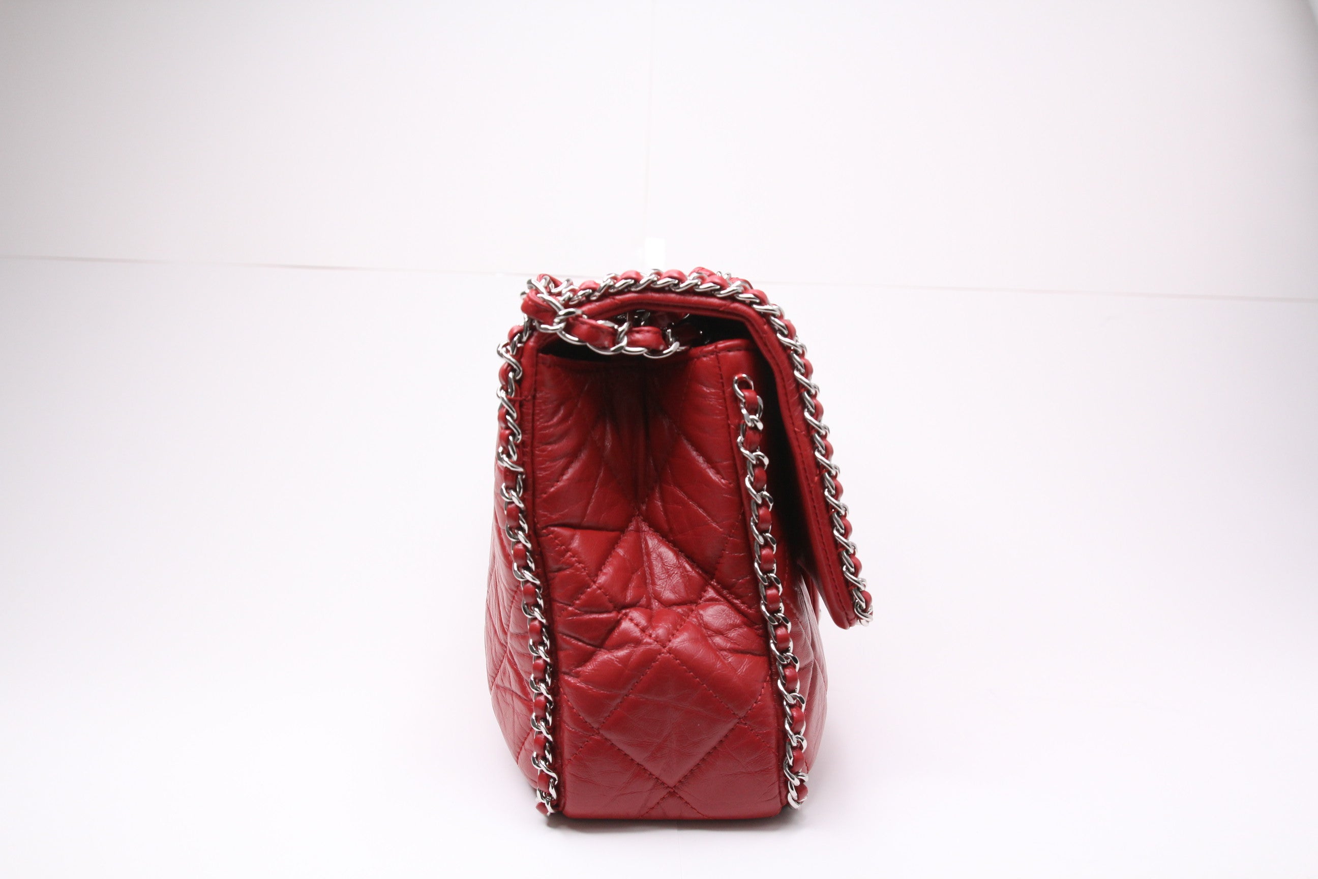 Side of large Chanel flap finished in aged red calfskin
